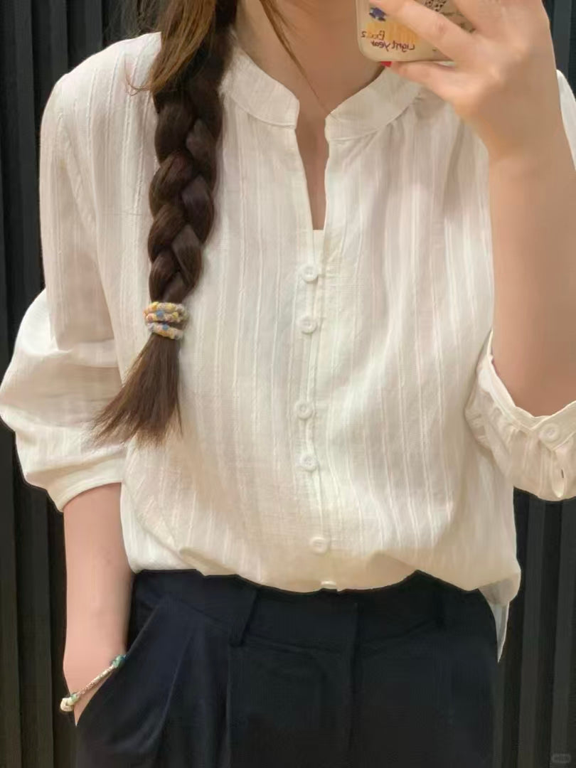 Cream white half-sleeve blouse - mirror selfie showing V-neck and textured stripe fabric with dark trousers