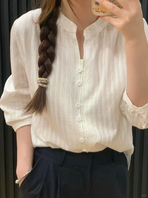 Cream white half-sleeve blouse - mirror selfie showing V-neck and textured stripe fabric with dark trousers