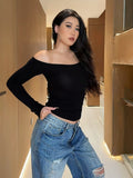 White off-shoulder top – side profile view showing cropped waist