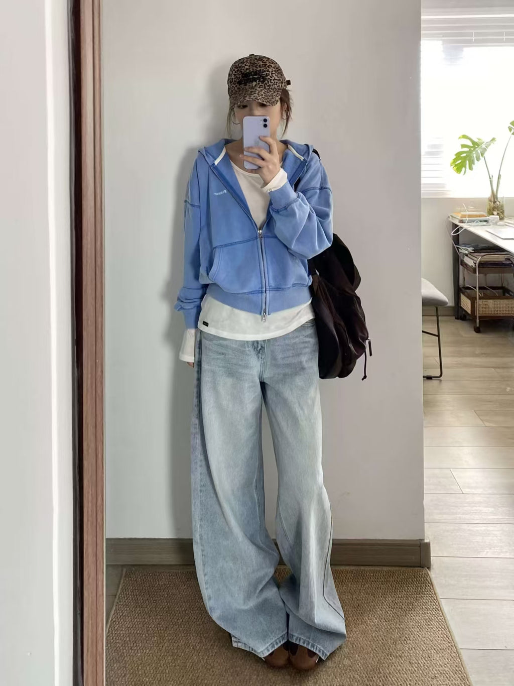 Light blue wide-leg jeans – full front view, model with arms raised