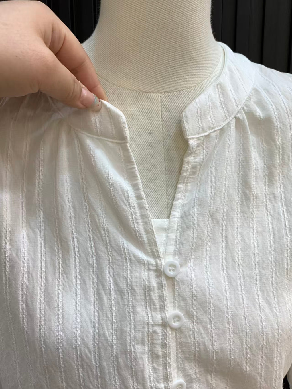 Blouse collar close-up on mannequin - V-neck stand collar and single-breasted button detail