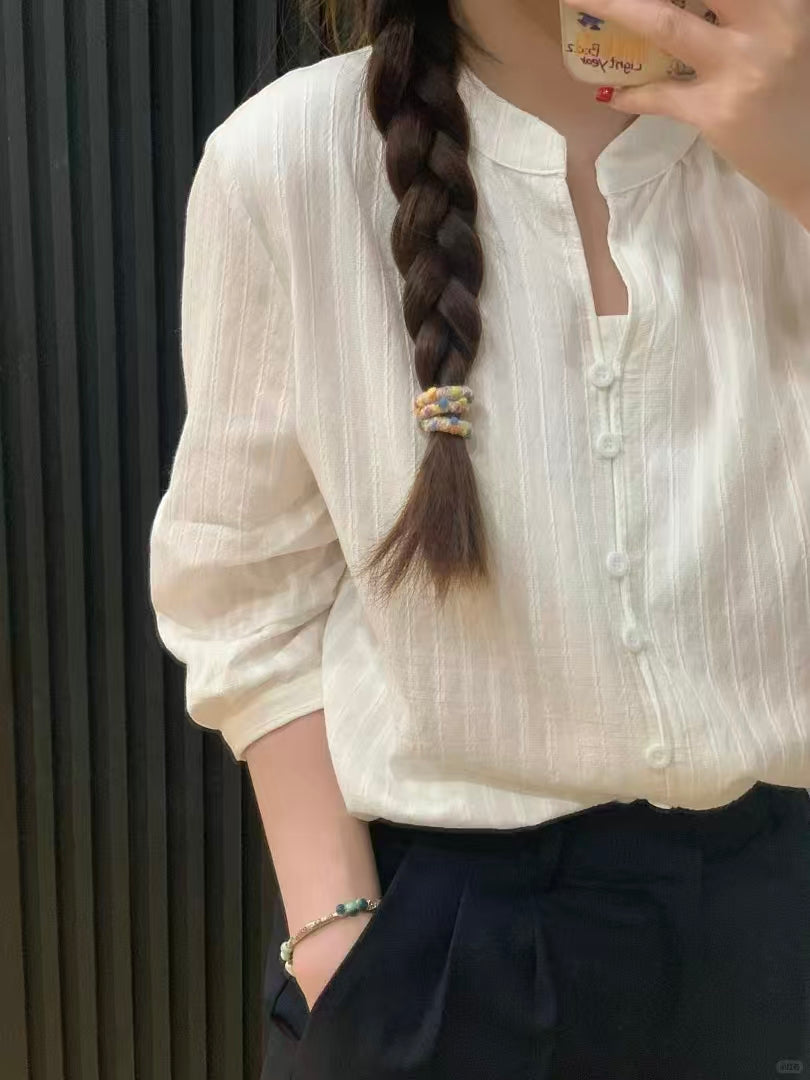 Cream white blouse - close-up of elbow-length sleeve and button front detail